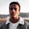 A young man with mountains in the background